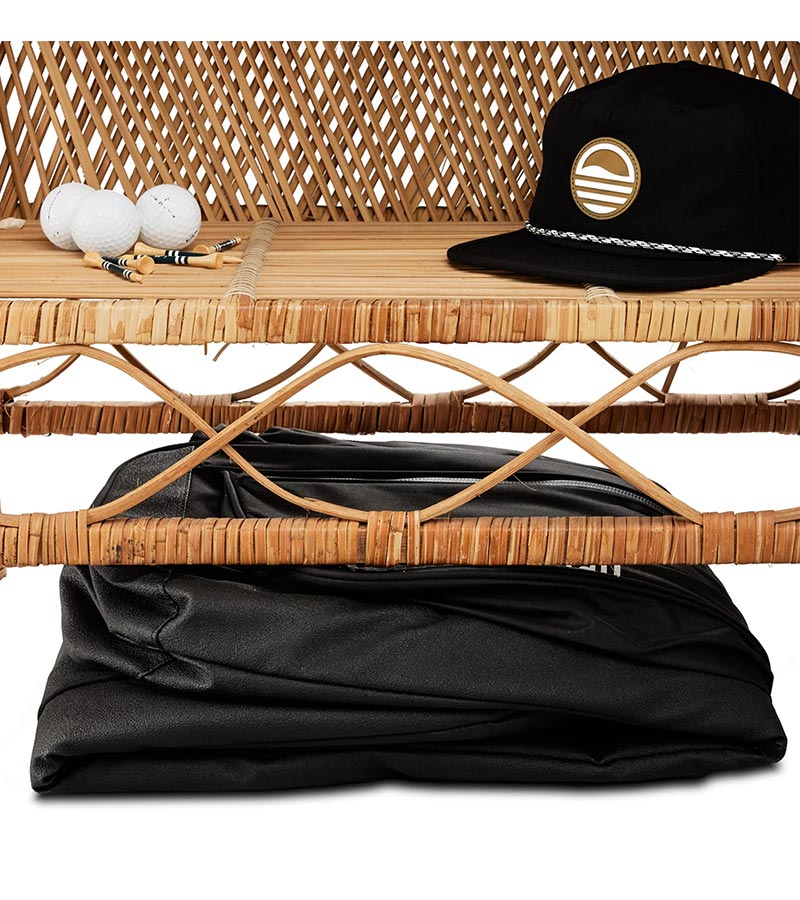 Sunday Golf The Mule Golf Travel Bag in black folded compactly beneath a bench