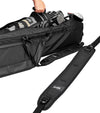 Sunday Golf The Mule Golf Travel Bag in black - partial view showing a hand lefting out a golf bag filled with clubs. In the foreg round is the padded carry strap.