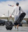 Sunday Golf The Mule Golf Travel Bag in black being carried over the shoulder by a man going to the airport.