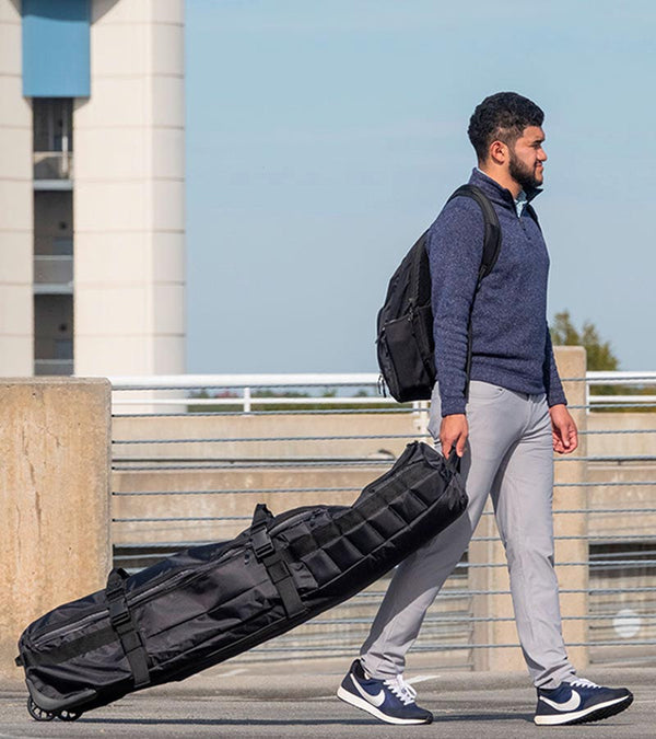 BAG BOY  ZTF Travel Bag Cover in black/charcoal detailing being pulled by a man.
