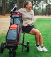 BagBoy Volt Electric Golf Cart with a Bagboy cart bag- Female golfer on fairway sitting of cart seat