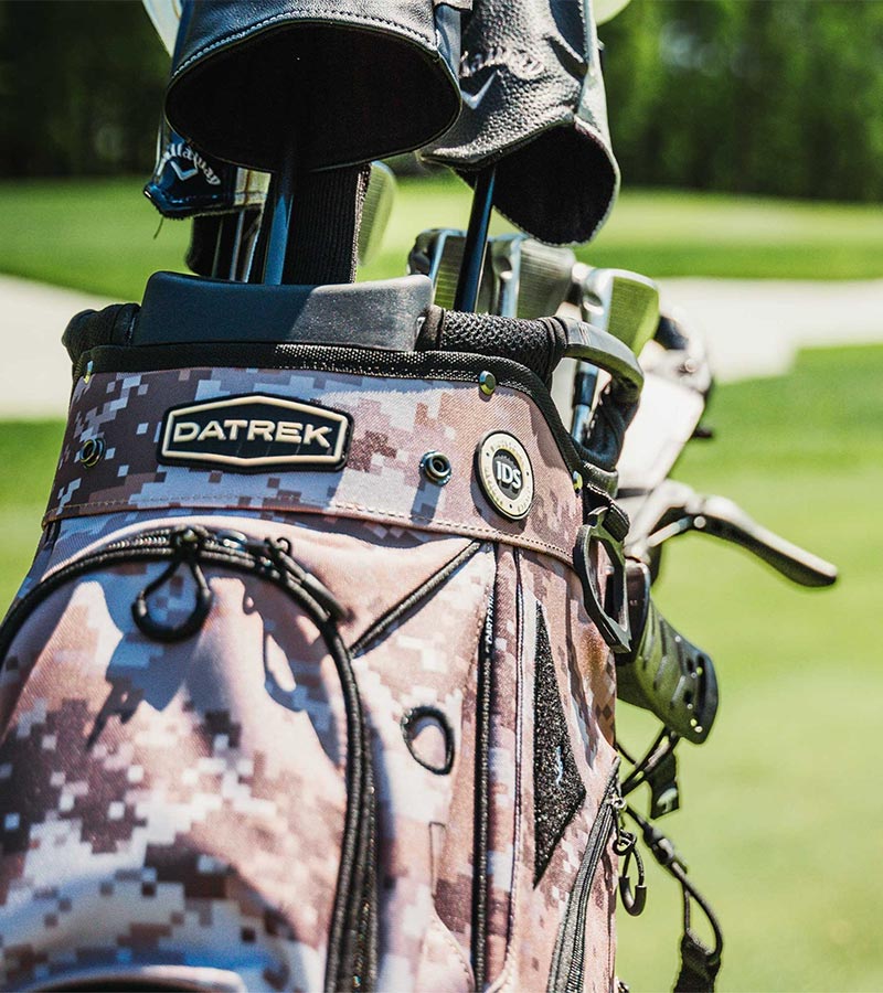 Datrek DG Lite III Golf Cart Bag in Digital Camo - closeup of top area with clubs showing the Dtrek logo on the cart