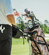 Datrek DG Lite III Golf Cart Bag in Digital Camo showing clubs in the bag with golfer selecting a clug on the fairway