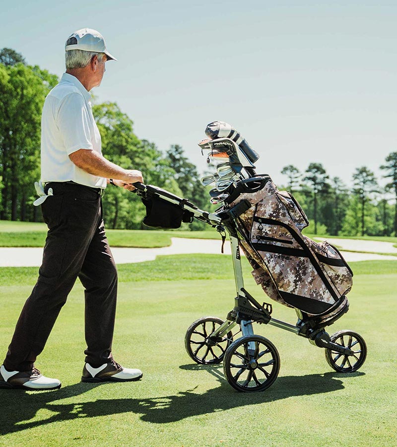 Datrek DG Lite III Golf Cart Bag in Digital Camo - riding on a cart bag pushed by senior golfer on the fairway.