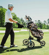 Datrek DG Lite III Golf Cart Bag in Digital Camo - riding on a cart bag pushed by senior golfer on the fairway.