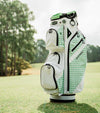 Datrek DG Lite III Golf Cart Bag in White/Green/Checkered upright on the fairway.