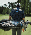 Golfer carrying on back the Datrek Go Lite Hybrid Golf Stand Bag in Black/Charcoal/Royal