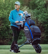 BagBoy Chiller Pro Hybrid Cart Golf Bag in Black/Royal/Charcoal on push cart with male golfer on the course