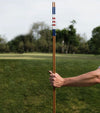 HazyGolf Alignment Sticks – American Glory - pair vertical held by a go;fer on a fairway