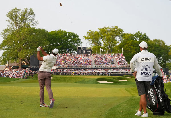 PGA Oak Hill Tournament/ final hole with viewers in stand/ Koepka and caddy in forground