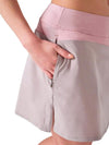 Inphorm BAILA 15" Golf Skirt in Dusty Pink/Latte - partial model - closeup side view with hand in pocket