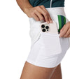 Pirdie Foreplay Skirt in White - partial model 3quarter holding a cell phone