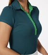 Pirdie June Daly Womens Golf Polo -partial model in Teal - 3quarter view with Kelly Green button placket & puffef short sleeve