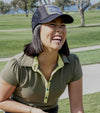 Pirdie June Daly Womens Golf Polo - in Olive Green - partial model on the golf course- front view