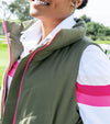 Pirdie Twilight Golf Vest in Olive Green with accents in hot pink for the zipper -partial model - closeup of zipper and collar