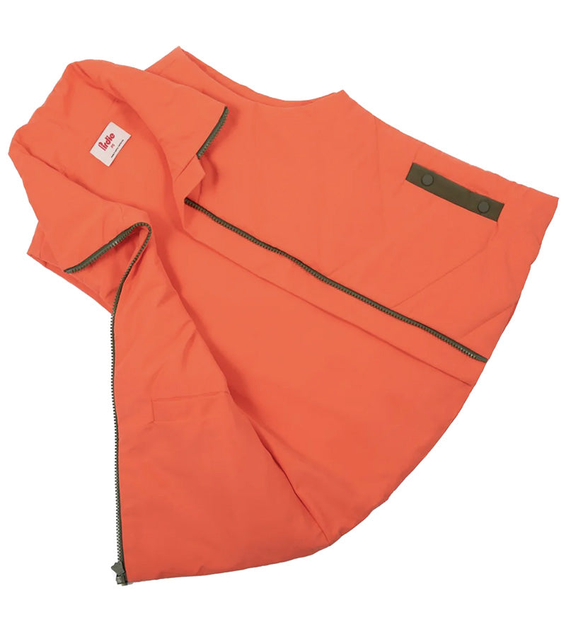 Pirdie Twilight Golf Vest unzipped and opened in Hot Coral with accents in olive green for the zipper and pocket details