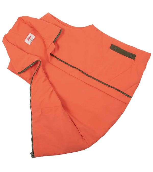 Pirdie Twilight Golf Vest unzipped and opened in Hot Coral with accents in olive green for the zipper and pocket details