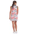Puma MATTR Beautiful Game Womans Golf Dress- model in a tropical White Glow / Peach Frost print with green collar and green banded armholes - back view