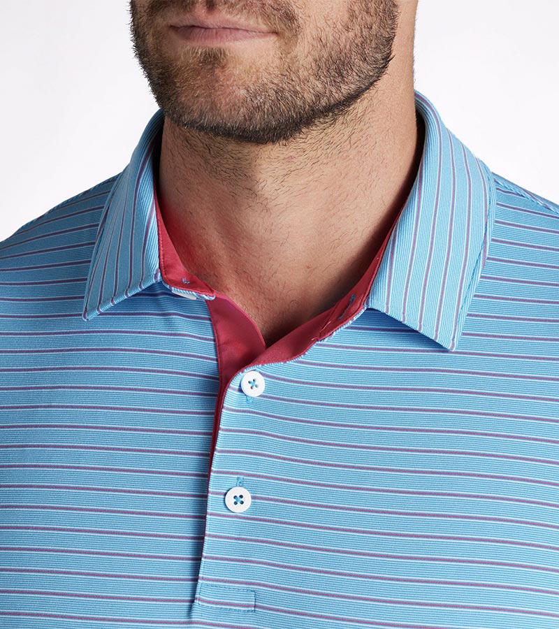 Puma Mens MATTR Bay Golf Polo Model Front in Garnet Rose / Aqua Blue with simple thin stripes in 2 different colors. Closeup of the collar and 3-button placket lined in red.