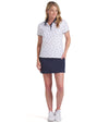 Puma Volition Dancing Stars Short Sleeve Women’s Golf Polo Shirt with model - front view in White Glow with navy stars