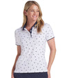 Puma Volition Dancing Stars Short Sleeve Women’s Golf Polo Shirt with partial model- front view in White Glow with navy stars