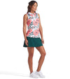 Puma MATTR Hadley Sleeveless Womens Golf Polo Shirt - model, 3 quarter view in White Glow / Peach Frost an an eye-catching floral print in vibrant coral pink and lush green tones