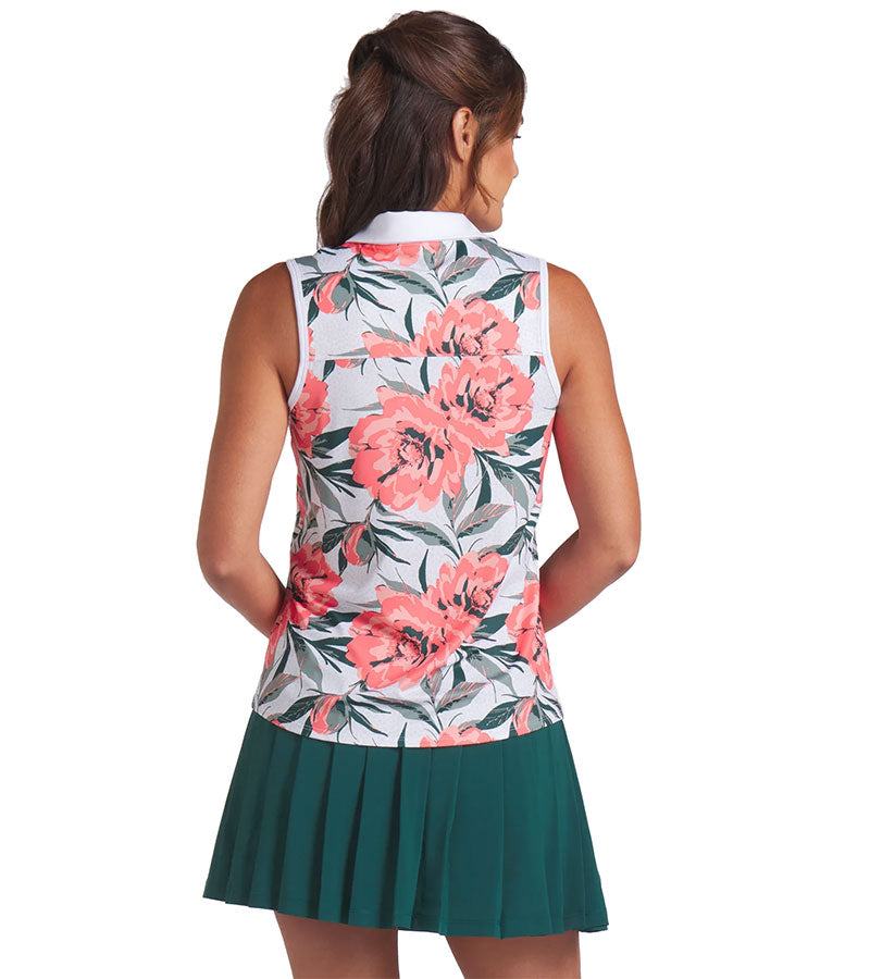 Puma MATTR Hadley Sleeveless Womens Golf Polo Shirt - partial model, back view in White Glow / Peach Frost an an eye-catching floral print in vibrant coral pink and lush green tones