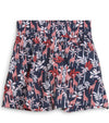 Puma Women’s Sandy Printed Golf Skirt front view in Deep Navy -a bold navy jungle print with playful red giraffes among the foliage