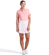 Puma Womens Sandy Printed Golf Skirt in Pink Fruit, a pink floral toile with subtle cats - front view of model