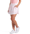 Puma Womens Sandy Printed Golf Skirt in Pink Fruit, a pink floral toile with subtle cats - front view of partial model