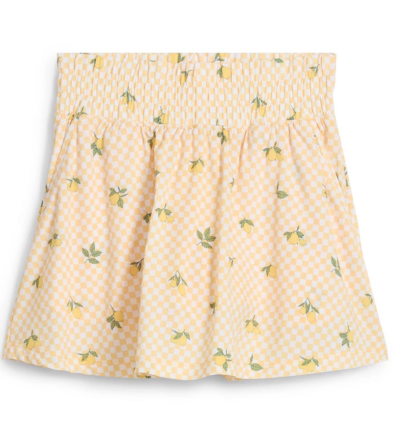 Puma Womens Sandy Printed Golf Skirt in Sunny Yellow, a print of tossed yellow lemons and green leaves against a gingham background - front view of partial model