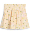 Puma Womens Sandy Printed Golf Skirt in Sunny Yellow, a print of tossed yellow lemons and green leaves against a gingham background - front view of partial model