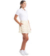 Puma Womens Sandy Printed Golf Skirt in Sunny Yellow, a print of tossed yellow lemons and green leaves against a gingham background - 3 quarter view of model