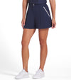 Puma x AP Solid Women’s Golf Shorts- partial model -front in Deep Navy with contrast white piping on the pockets