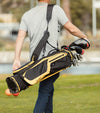 The Sunday Golf El Camino mid-size Stand Golf Bag in Black & Yellow being carried on 1 shoulder by male golfer