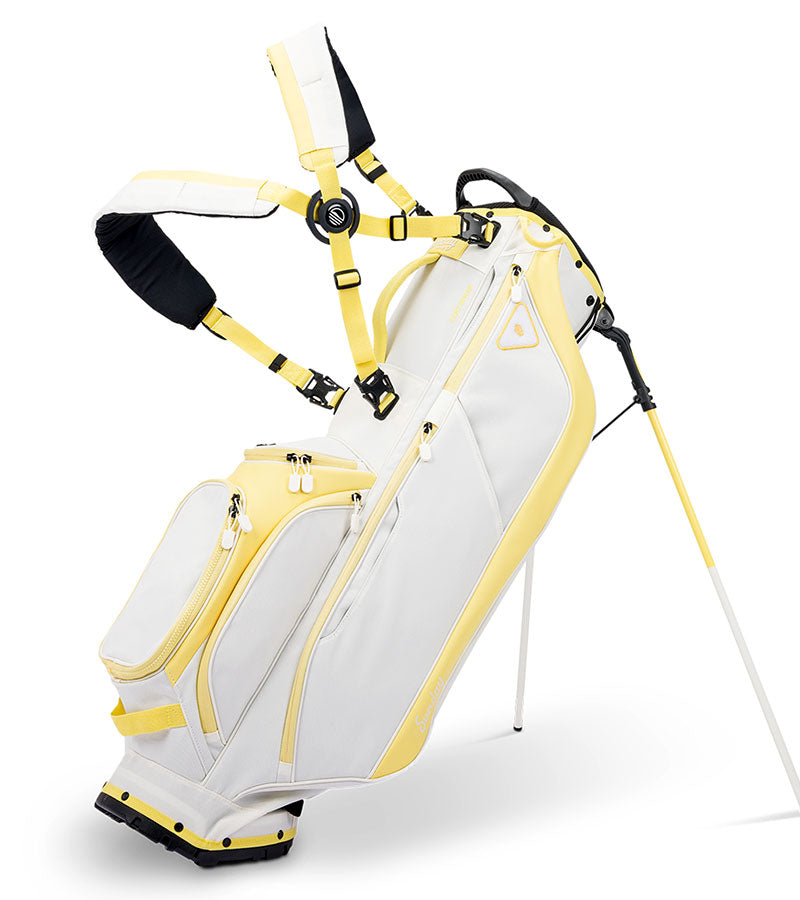 Sunday Golf Ryder Full Size Stand Golf Bag in Mindy Yellow with legs extended and a backpack-style double strap system