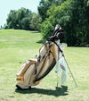 Sunday Golf Ryder Full Size Stand Golf Bag in Toasted Almond with legs extended on the green with clubs and other golf esentials attached.