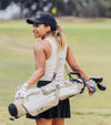 Sunday Golf The Loma Par 3 Golf Bag in Toasted Almond with women golfer carrying the bag on her back
