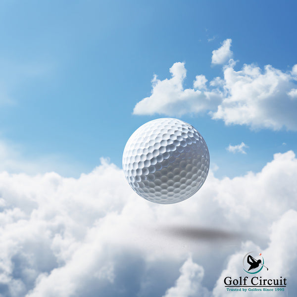 Single white golf ball in the sky with clouds.