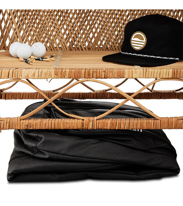 Sunday Golf The Mule Golf Travel Bag in black folded compactly beneath a bench