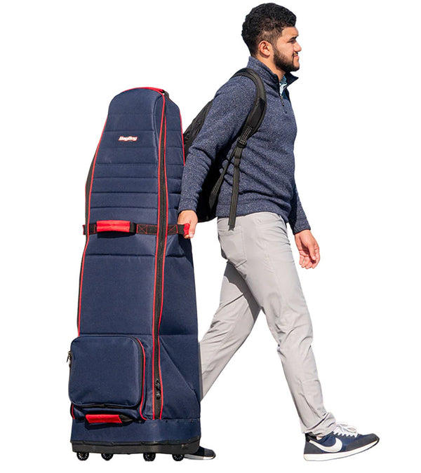 Bagboy Freestyle Travel Cover-standing upright in Navy/Red being pulled by man wearingsweater and chinos