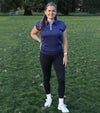 Birdie & Ace Lily Womens Golf Polo in Navy - model standing on the fairway