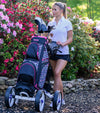 DG Lite ll Womens Golf Cart Bag
in Blue Flamingo -Woman golfer with bag in a push cart on golf path with azelea bushes.