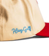 Hazy Golf HG 2 Tone Cardinal and Bone Snapback - closeup of blue Hazy Golf embroidered logo on side with Cardinal red visor 