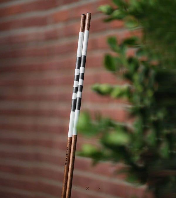 HazyGolf Alignment Sticks – Wolf in Sheep's Clothing- vertical pair aginst a brick wall with shrubs