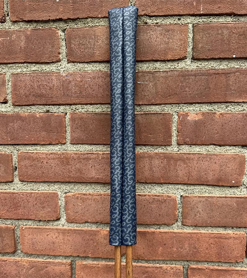 Hazy Golf All Over Alignment Sticks Cover- showing each sleeve against  brick wall