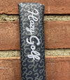 Hazy Golf All Over Alignment Sticks Cover- closeup of embroidery against a brick wall