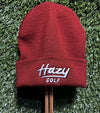 Hazy Golf Portland Logo Cuffed Beanies- front view with logo on cuff- in Cardinal on grass back ground