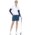 Inphron Womens Logan Performance Long Sleeve Half Zip Top in White/Ink - model front view with golf club