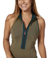 Pirdie Sleeveless Duchess Womens Golf Dress in Olive Green-partial model showing closeup of front with black zipper and neckline and arm holes accented in dark teal